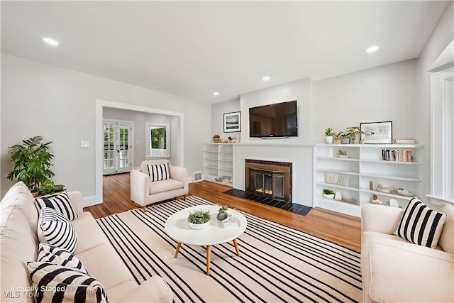 3020 E Derbyshire Rd, Cleveland Heights, OH 44118 - living room with wood finished floors, a fireplace with flush hearth, recessed lighting, french doors, and baseboards