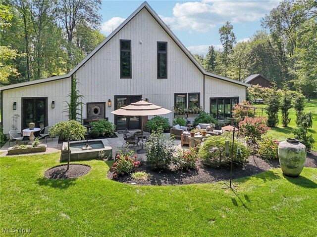 7090 Country Ln, Chagrin Falls, OH 44023 - back of property featuring a lawn, a patio, and an outdoor living space