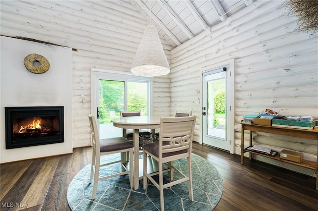 7090 Country Ln, Chagrin Falls, OH 44023 - dining space with rustic walls, wood ceiling with exposed beams, dark wood-style flooring, high vaulted ceiling, and a glass covered fireplace