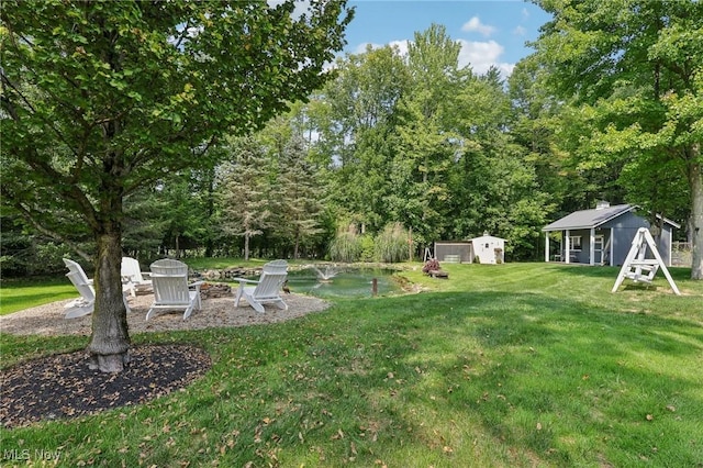 7090 Country Ln, Chagrin Falls, OH 44023 - view of green lawn with an outbuilding and an outdoor fire pit