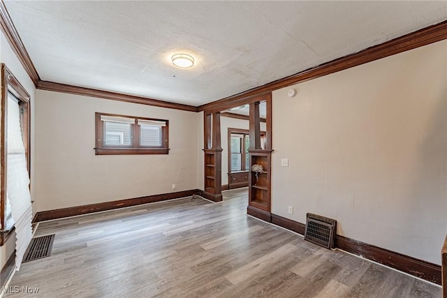 906 Beardsley St, Akron, OH 44311 - spare room featuring ornamental molding, wood finished floors, baseboards, and ornate columns
