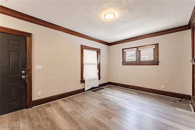 906 Beardsley St, Akron, OH 44311 - empty room featuring light wood-style floors, baseboards, and crown molding