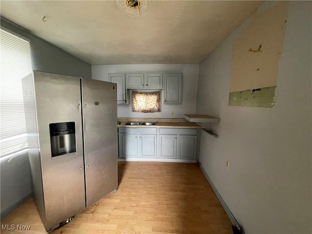 1400 Center St, Wellsville, OH 43968 - kitchen with stainless steel fridge with ice dispenser, light wood finished floors, a sink, and gray cabinetry