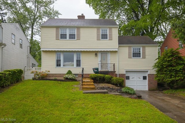 3762 Covington Rd, South Euclid, OH 44121 - colonial-style house with an attached garage, a chimney, and driveway