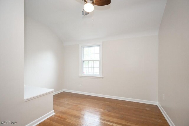 3762 Covington Rd, South Euclid, OH 44121 - empty room with lofted ceiling, wood finished floors, baseboards, and a ceiling fan