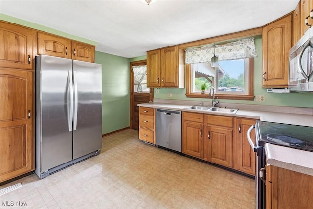22938 US Route 30, Minerva, OH 44657 - kitchen featuring stainless steel appliances, a sink, brown cabinets, and light countertops