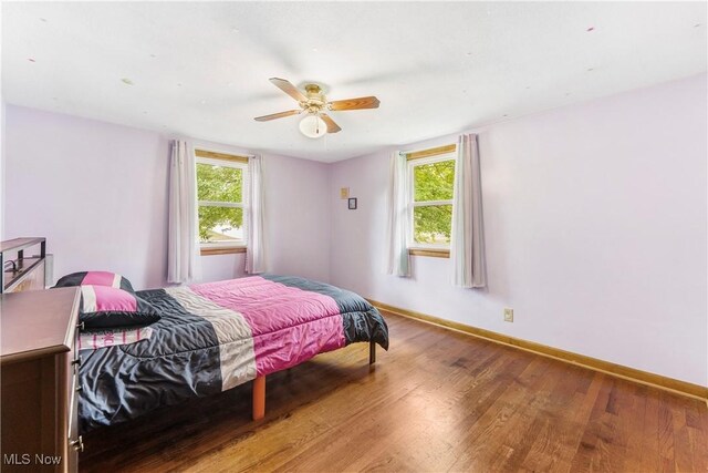 22938 US Route 30, Minerva, OH 44657 - bedroom featuring wood finished floors, baseboards, and ceiling fan