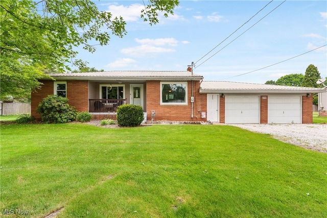 22938 US Route 30, Minerva, OH 44657 - ranch-style house with covered porch, a front yard, brick siding, and an attached garage