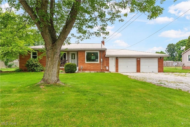 22938 US Route 30, Minerva, OH 44657 - ranch-style home with a front lawn, a garage, brick siding, and metal roof