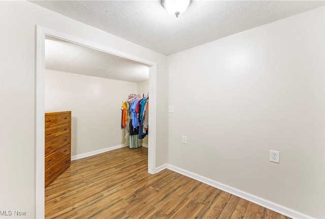 22938 US Route 30, Minerva, OH 44657 - unfurnished room featuring wood finished floors, baseboards, and a textured ceiling