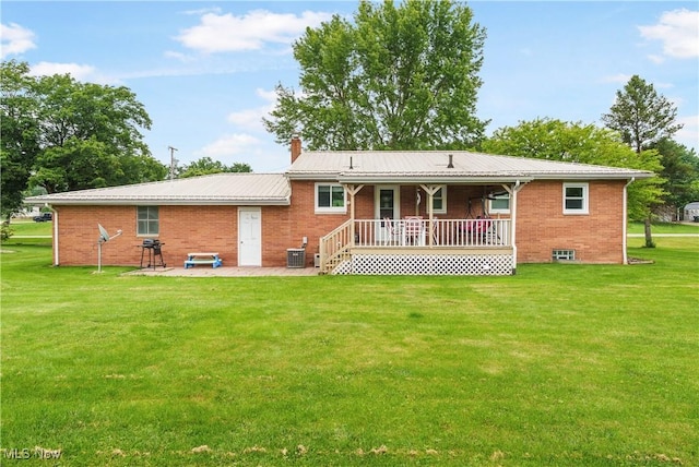 22938 US Route 30, Minerva, OH 44657 - rear view of house with a yard, covered porch, brick siding, and a chimney