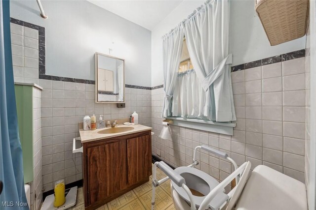 7100 Barton Rd, North Olmsted, OH 44070 - bathroom featuring tile walls, vanity, and wainscoting