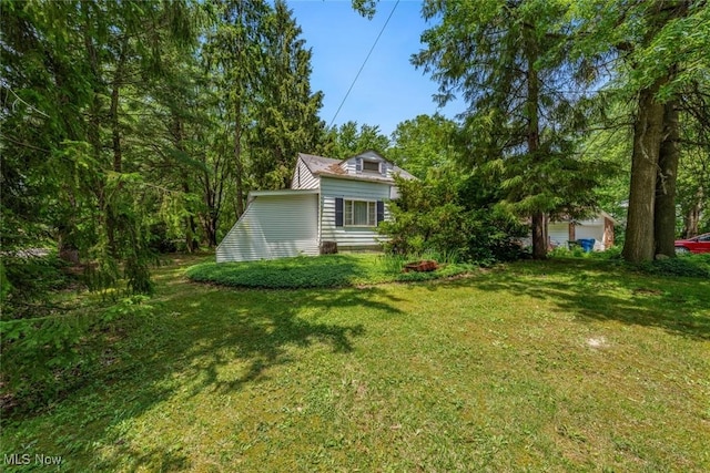 7100 Barton Rd, North Olmsted, OH 44070 - view of green lawn with a garage