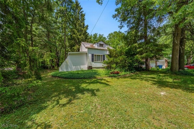 7100 Barton Rd, North Olmsted, OH 44070 - view of grassy yard featuring a garage