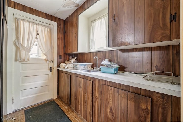 7100 Barton Rd, North Olmsted, OH 44070 - kitchen with wood walls, light countertops, and brown cabinets