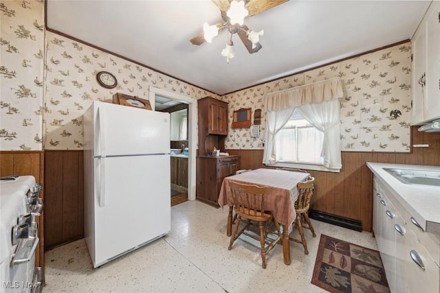 7100 Barton Rd, North Olmsted, OH 44070 - kitchen with freestanding refrigerator, a wainscoted wall, wallpapered walls, gas range, and light countertops