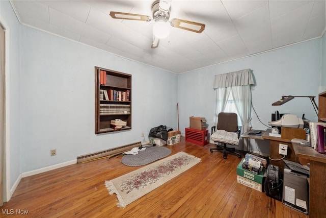 7100 Barton Rd, North Olmsted, OH 44070 - office featuring a baseboard heating unit, wood-type flooring, a ceiling fan, crown molding, and baseboards