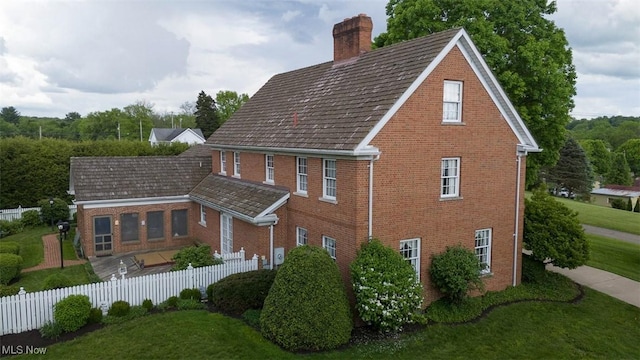 195 W 5th St, Zoar, OH 44622 - view of property exterior featuring a chimney and brick siding