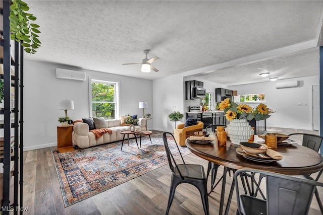 225 E Bergey St, Wadsworth, OH 44281 - dining space with a wall mounted AC, ceiling fan, light wood-type flooring, and a textured ceiling