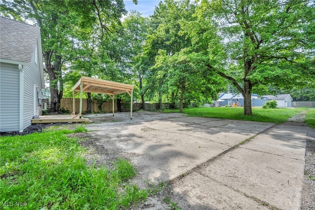 225 E Bergey St, Wadsworth, OH 44281 - view of patio / terrace featuring a carport, concrete driveway, and a deck