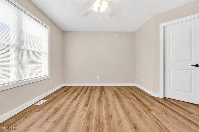 1255 E 351st St, Eastlake, OH 44095 - empty room featuring healthy amount of natural light, ceiling fan, light wood finished floors, and baseboards