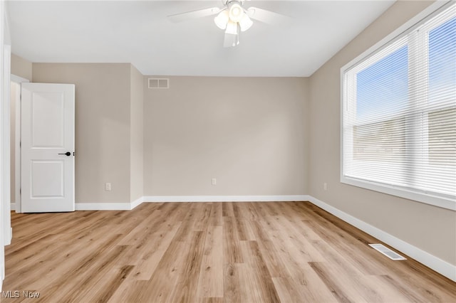 1255 E 351st St, Eastlake, OH 44095 - spare room with light wood-style floors, a ceiling fan, and baseboards