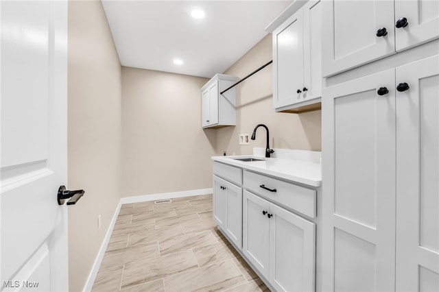 1255 E 351st St, Eastlake, OH 44095 - washroom featuring a sink, baseboards, recessed lighting, and light marble finish flooring