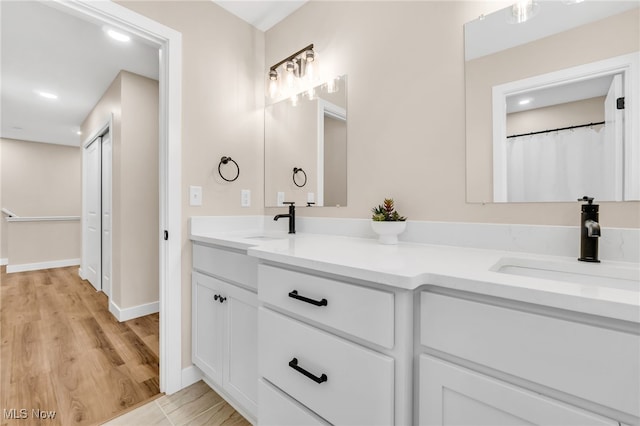 1255 E 351st St, Eastlake, OH 44095 - full bathroom featuring double vanity, recessed lighting, baseboards, and wood finished floors