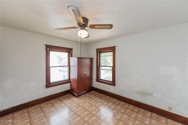 1222 W 6th St, Lorain, OH 44052 - spare room with light flooring, baseboards, and a ceiling fan