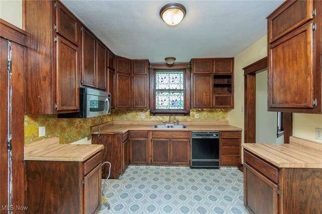 1222 W 6th St, Lorain, OH 44052 - kitchen featuring black dishwasher, a sink, decorative backsplash, light countertops, and stainless steel microwave