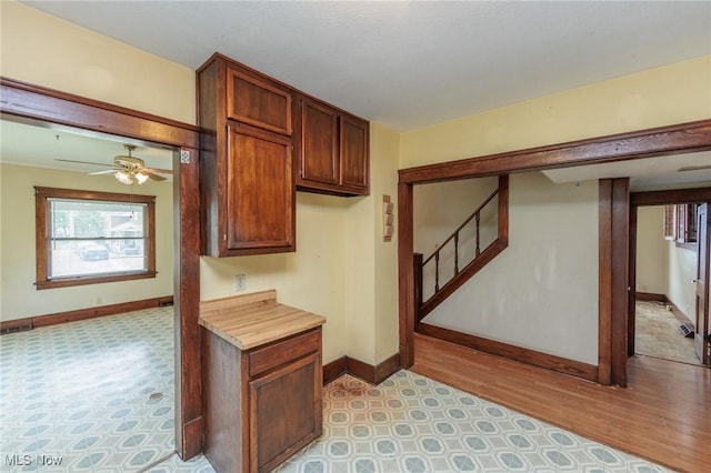 1222 W 6th St, Lorain, OH 44052 - kitchen with baseboards, light countertops, light floors, and ceiling fan