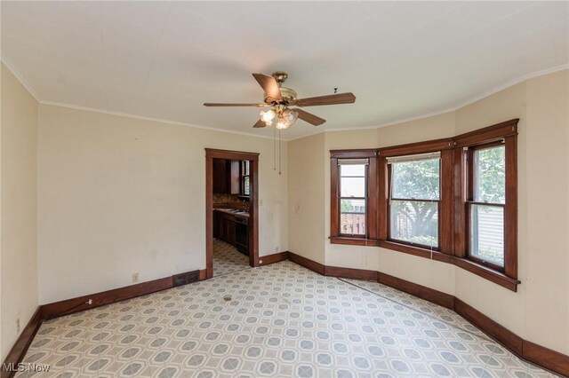 1222 W 6th St, Lorain, OH 44052 - spare room featuring baseboards, ceiling fan, ornamental molding, and light floors