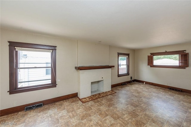 1222 W 6th St, Lorain, OH 44052 - unfurnished living room featuring baseboards and a fireplace