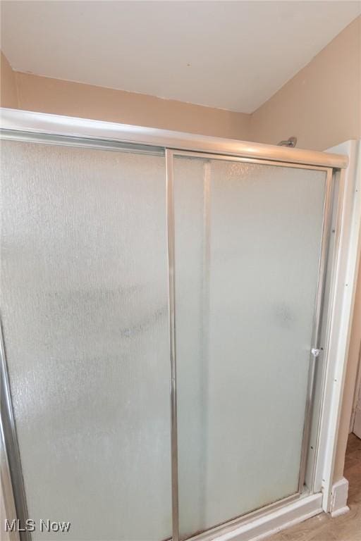 1222 W 6th St, Lorain, OH 44052 - bathroom with a stall shower and wood finished floors