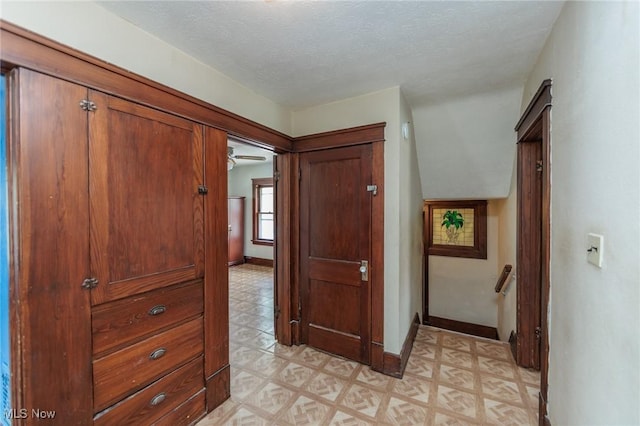 1222 W 6th St, Lorain, OH 44052 - hall featuring light flooring, baseboards, an upstairs landing, and a textured ceiling
