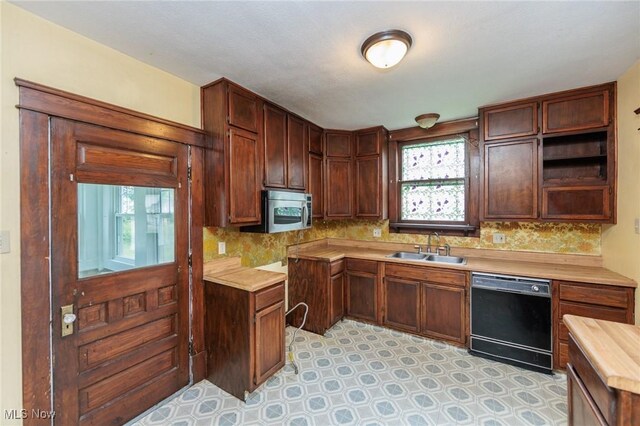 1222 W 6th St, Lorain, OH 44052 - kitchen with black dishwasher, a sink, stainless steel microwave, backsplash, and open shelves