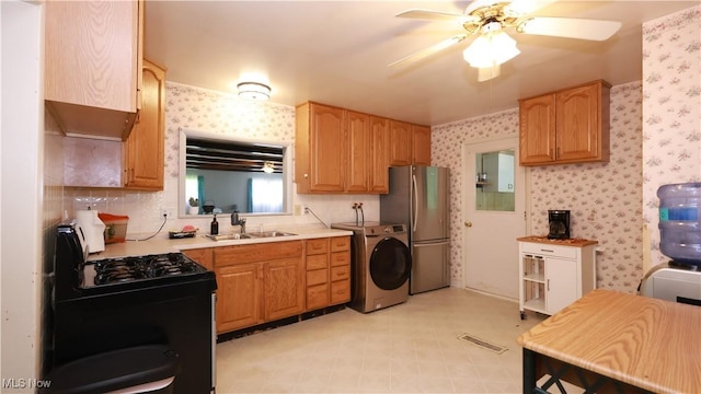 3221 Greenfield St NW, Warren, OH 44485 - kitchen with washer / clothes dryer, freestanding refrigerator, black gas stove, a ceiling fan, and light countertops