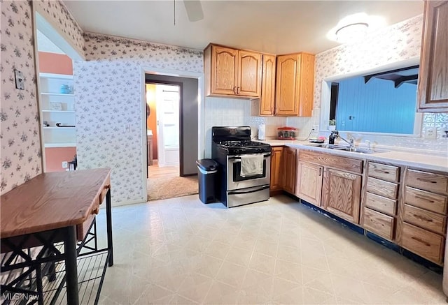 3221 Greenfield St NW, Warren, OH 44485 - kitchen with gas range, wallpapered walls, a ceiling fan, light flooring, and light countertops