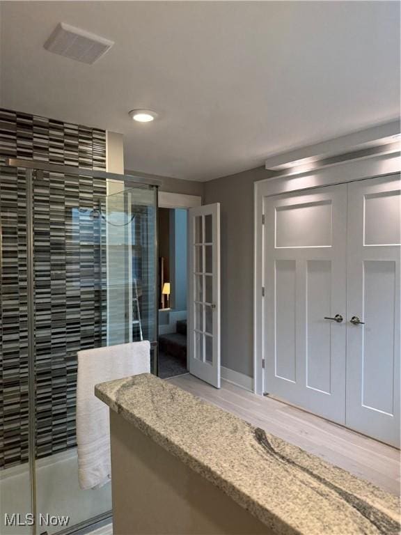 5771 E Blvd NW, Canton, OH 44718 - full bathroom with a shower stall, wood finished floors, recessed lighting, and french doors