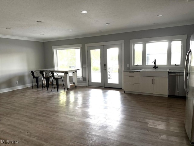 5771 E Blvd NW, Canton, OH 44718 - dining space with ornamental molding, plenty of natural light, a textured ceiling, french doors, and wood finished floors