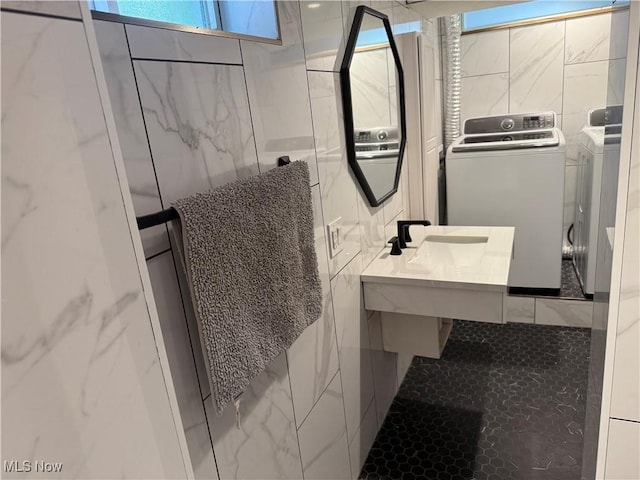 5771 E Blvd NW, Canton, OH 44718 - bathroom with washing machine and clothes dryer and tile walls
