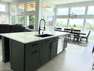 5771 E Blvd NW, Canton, OH 44718 - kitchen with plenty of natural light, stainless steel dishwasher, a kitchen island with sink, and light countertops