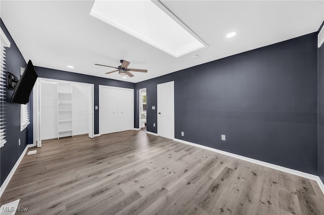 4371 Pine Lake Dr, Medina, OH 44256 - unfurnished bedroom featuring multiple closets, wood finished floors, baseboards, a ceiling fan, and recessed lighting