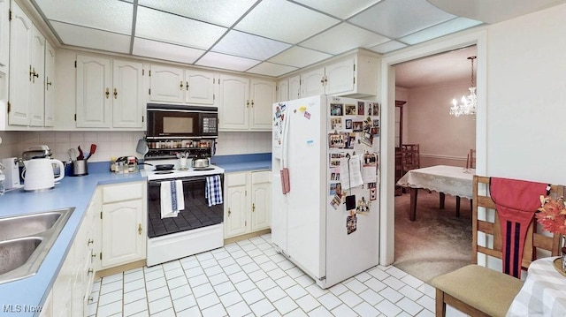 2385 Covington Rd Unit 102, Akron, OH 44313 - kitchen with white appliances, a sink, a chandelier, decorative backsplash, and light countertops