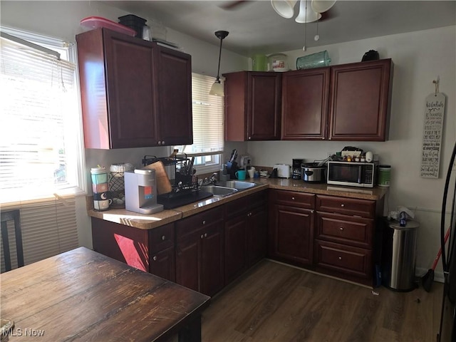 926 E 218th St, Euclid, OH 44119 - kitchen with dark wood finished floors, a ceiling fan, a sink, and hanging light fixtures