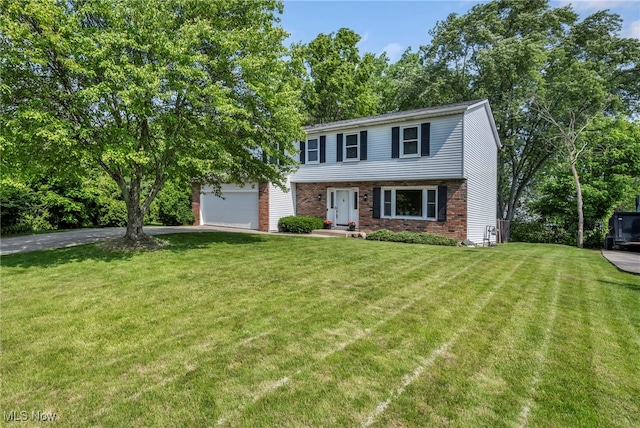 3895 Mars Dr, Brunswick, OH 44212 - colonial-style house featuring brick siding, a garage, a front lawn, and driveway