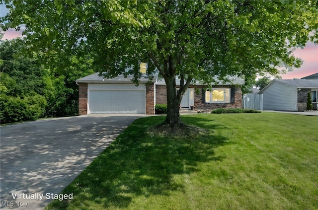 3895 Mars Dr, Brunswick, OH 44212 - obstructed view of property featuring concrete driveway, an attached garage, a yard, and brick siding