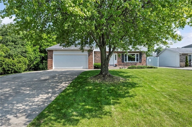 3895 Mars Dr, Brunswick, OH 44212 - view of front of house featuring brick siding, a garage, concrete driveway, and a front lawn