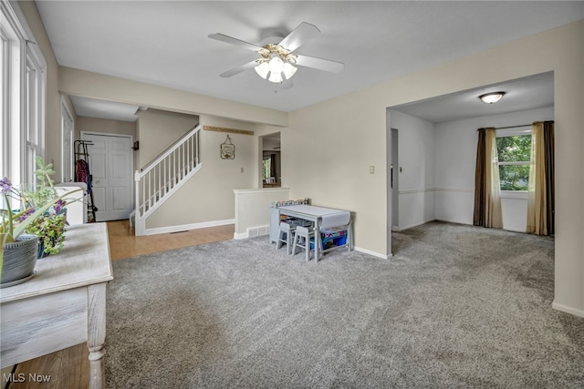 3895 Mars Dr, Brunswick, OH 44212 - unfurnished living room featuring carpet floors, baseboards, a ceiling fan, and stairs