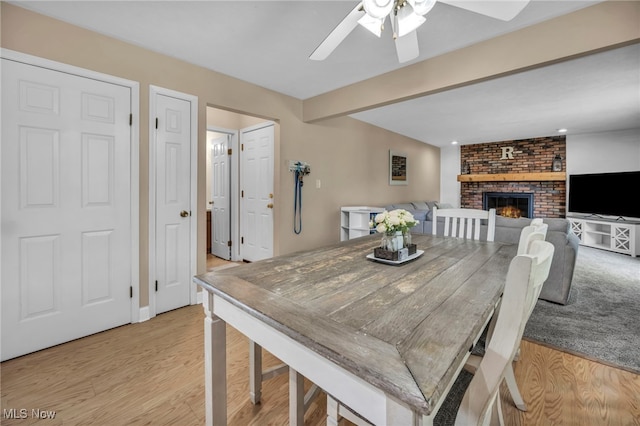 3895 Mars Dr, Brunswick, OH 44212 - dining area with ceiling fan, a fireplace, light wood finished floors, and beam ceiling
